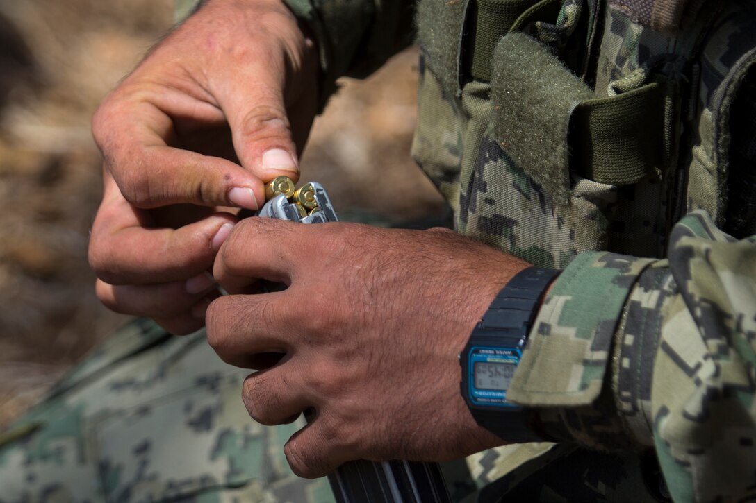 A Mexican marine with the Amphibious Marine Infantry Brigade loads rounds into a magazine before a live-fire event during Rim of the Pacific (RIMPAC) exercise at Marine Corps Base Camp Pendleton, California, July 3, 2018. RIMPAC demonstrates the value of amphibious forces and provides high-value training for task-organized, highly-capable Marine Air-Ground Task Forces enhancing the critical crisis response capability of U.S. forces and partners globally. Twenty-five nations, 46 ships, five submarines, about 200 aircraft and 25,000 personnel are participating in RIMPAC from June 27 to Aug. 2 in and around the Hawaiian Islands and Southern California.