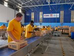 Sailors assigned to the forward-deployed aircraft carrier, USS Ronald Reagan (CVN 76), pack food boxes scheduled to be delivered to Mount Mayon volcanic eruption victims during a community project with the Republic of the Philippines National Response and Logistics Management Services. More than 200 Ronald Reagan Sailors participated in eight community projects sponsored by the ship's Command Religious Ministries Department during a scheduled port visit to Manila, June 26-30. Ronald Reagan, the flagship of Carrier Strike Group 5, provides a combat-ready force that protects and defends the collective maritime interests of its allies and partners in the Indo-Pacific region.