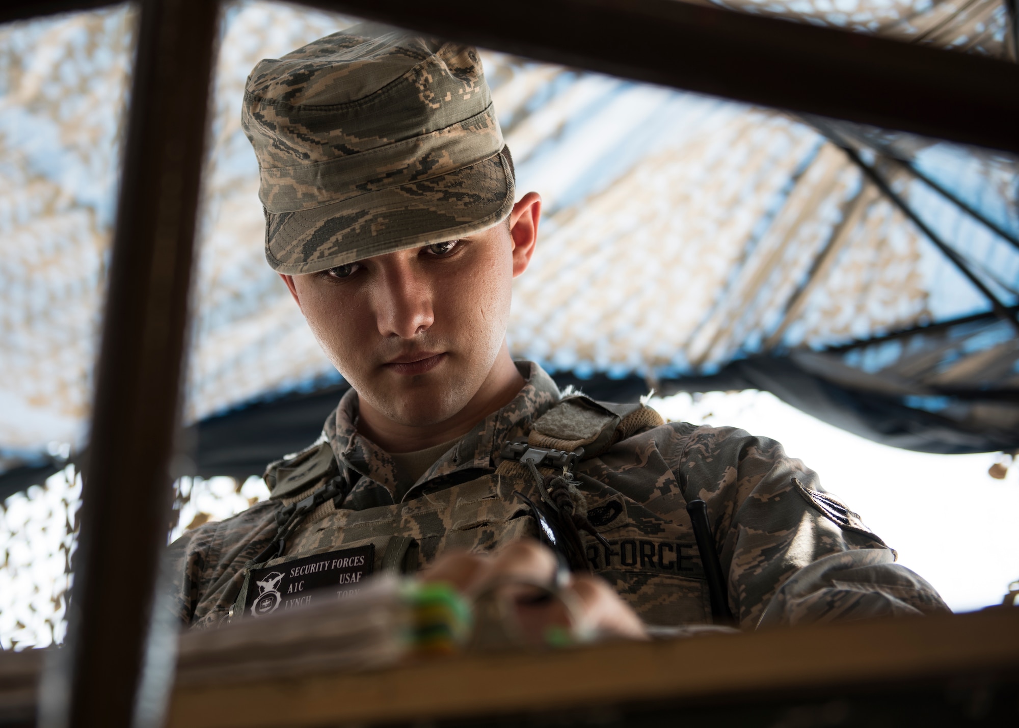 U.S. Air Force Airman 1st Class Tory Lynch, 39th Security Forces Squadron, inspects ID cards at Incirlik Air Base, Turkey, June 21, 2018.