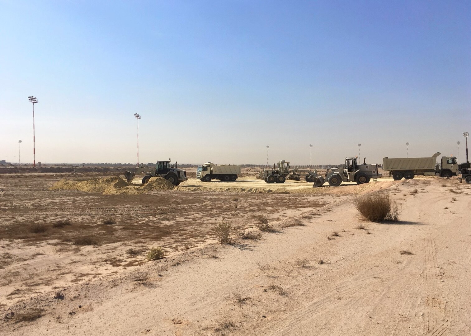 Airmen from the 386th Expeditionary Civil Engineer Squadron conduct a land survey at Cargo City, located at Abdullah Al Mubarak Air Base, Kuwait, November 11th, 2017. Before building the future home of the 387th Air Expeditionary Group, 5th Expeditionary Air Mobility Squadron, and other Joint and Coalition Partners, the land needed to be filled in, graded, and compacted, as the designated site was originally 10 feet below the ramp. (Courtesy photo)