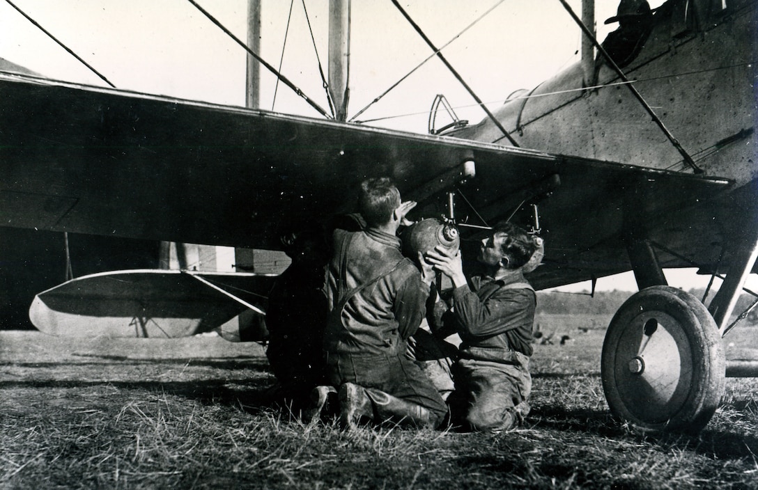 U.S. Marines attaching bomb to DH-4 (de Havilland) “Liberty Plane,” circa 1918 (Zimmer/Naval History and Heritage Command)