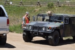 Colorado Army National Guardsmen, Private Joshua Breeden, radios higher authorities for an authorization tp pass for a civilian traveling through a road closer. Breeden is a member of Task Force Security assisting Boulder County Sheriff's Office with Cold Springs fire relief efforts in Boulder Colo., July 11, 2016.