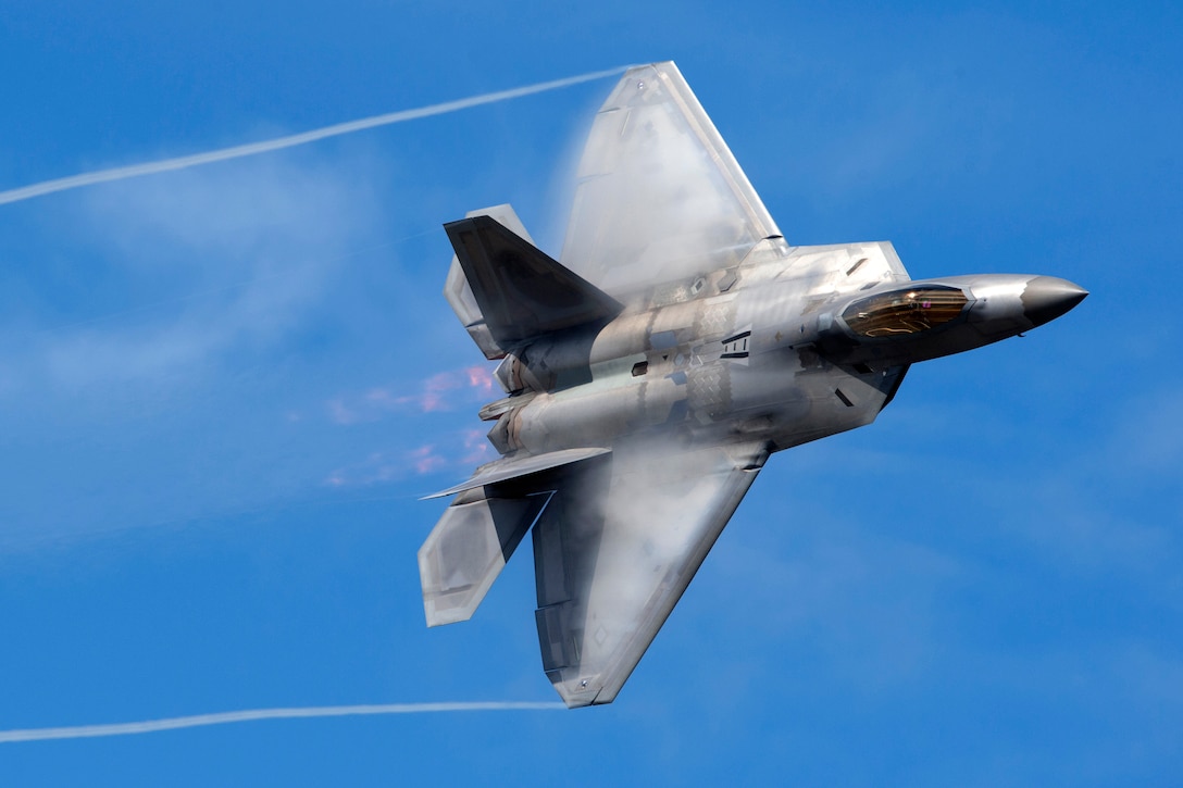 An Air Force F-22 Raptor aircraft performs aerial maneuvers.