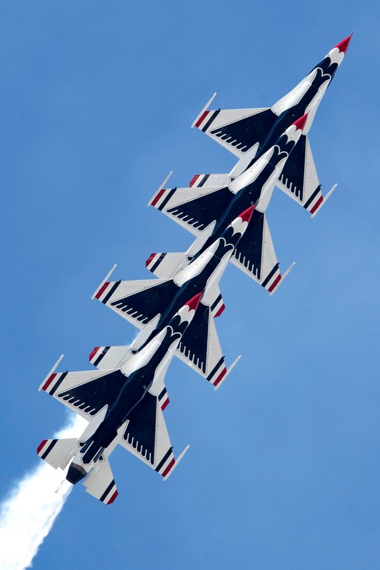 The U.S. Air Force Thunderbirds Demonstration Team performs a split-second aerial maneuver.