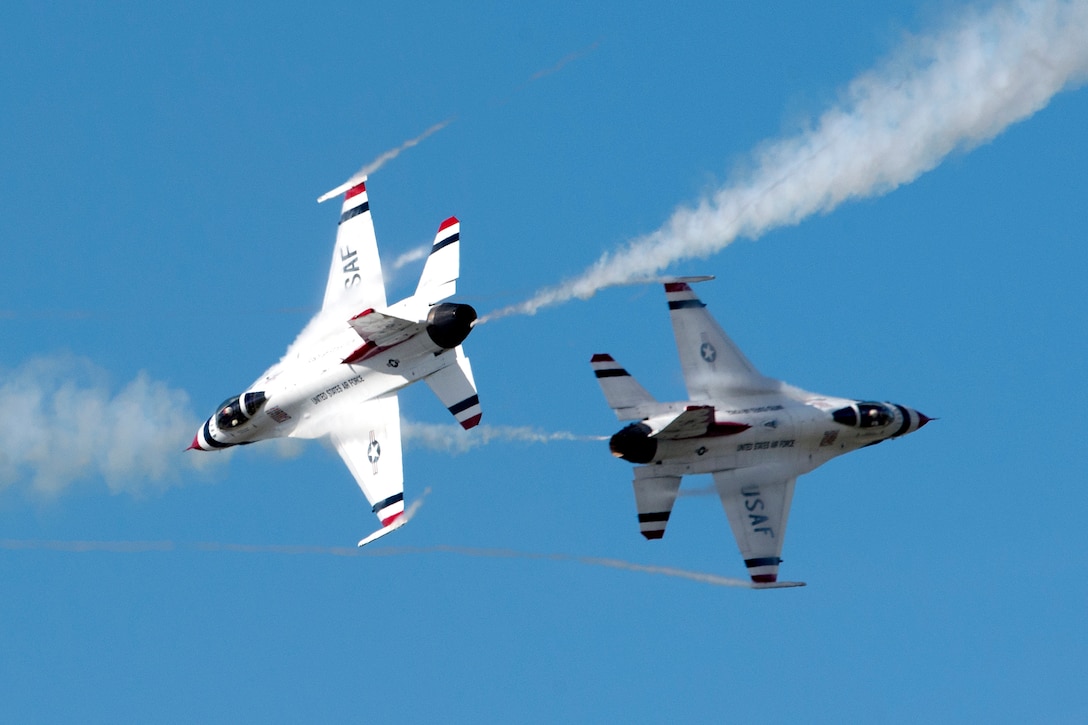 The U.S. Air Force Thunderbirds Demonstration Team intersect flight paths.