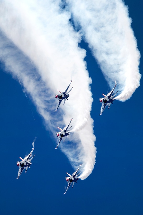 The U.S. Air Force Thunderbirds Demonstration Team adds plumes of smoke to their aerial maneuvers.