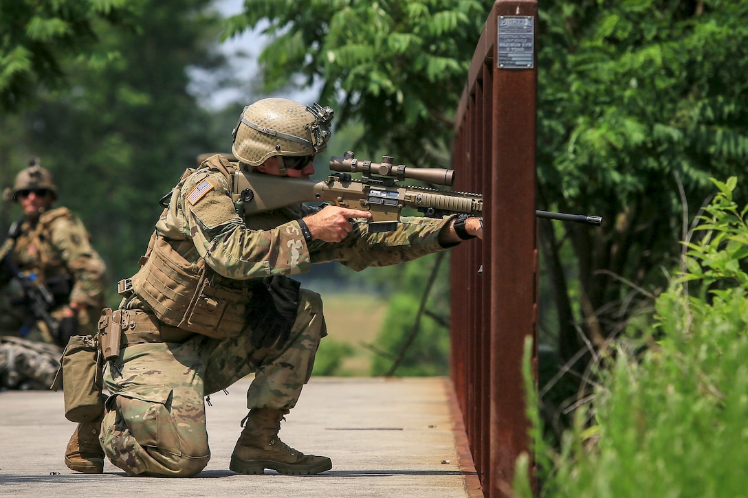 A soldier provides security from a bridge during a training exercise.