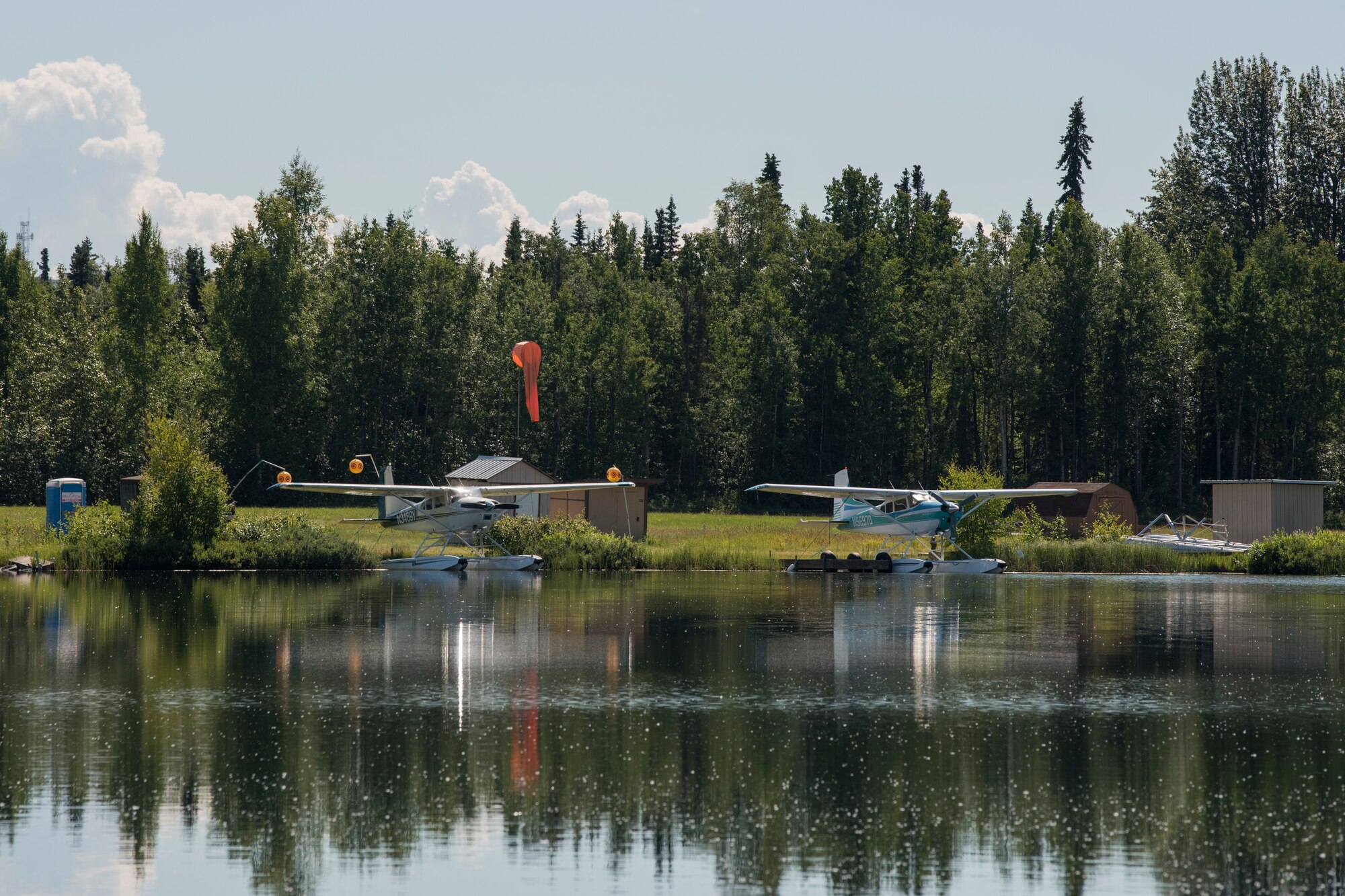 Private aircraft are docked at the Elmendorf Aero club water landing area and floating docks on Lower Sixmile Lake at Joint Base Elmendorf-Richardson, Alaska, July 2, 2018. The club offers rentable spaces for seaplanes, flying boats, and amphibious aircraft designed to take off and alight on water.