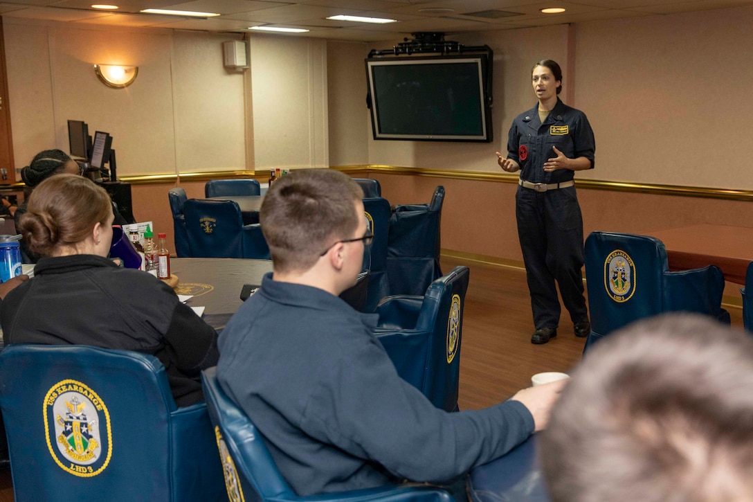 A Navy instructor briefs sailors before conducting training.