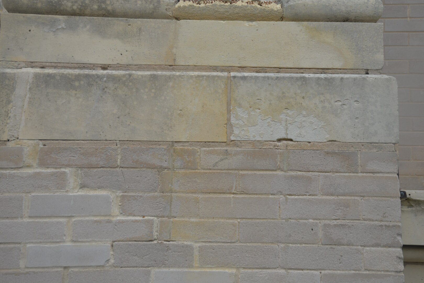 A photo taken after the exterior of the historic Main Post Chapel, or Gift Chapel, at Joint Base San Antonio-Fort Sam Houston underwent a steam cleaning in late April shows the black mold had been taken off a section of masonry in the back of the chapel. The cleaning got rid of dirt, pollution, organic material and the black mold that had formed and accumulated overtime on the exterior of the building. The cleaning of the Main Post Chapel was conducted following guidelines for the cleaning of historic masonry buildings by the U.S. Department of Interior and the National Park Service.