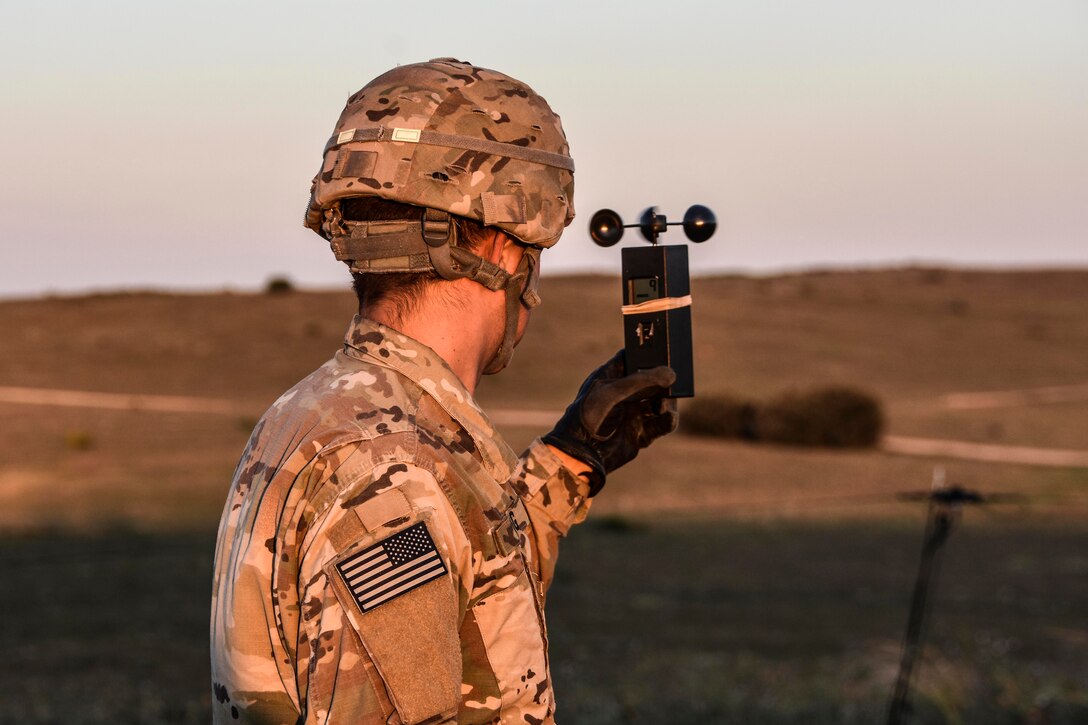 A soldier checks the wind speed before paratroopers conduct a Joint Forceable Entry airborne operation.