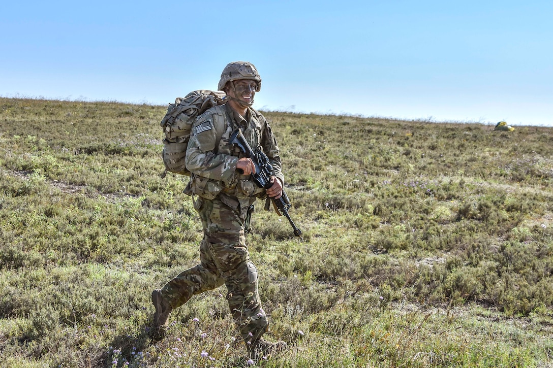 A paratrooper moves toward his follow-on position.