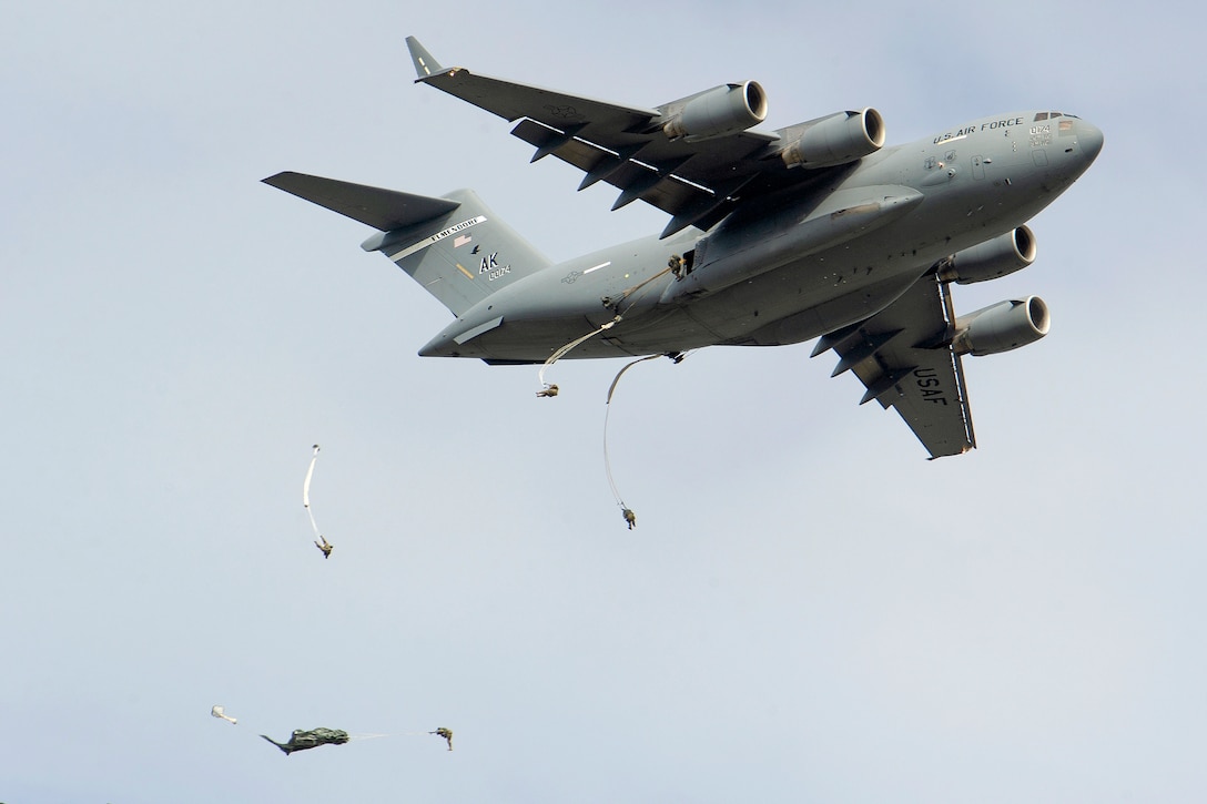 Soldiers jump from an Air Force C-17 Globemaster III.
