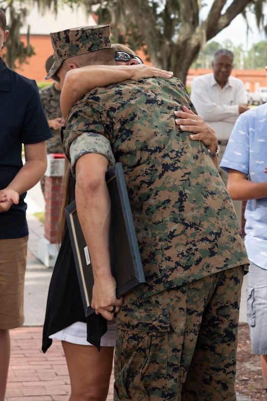 Tammie Ashely embraces Gunnery Sgt. Justin Boyer to congratulate him after his promotion ceremony aboard Marine Corps Recruit Depot Parris Island July 2.