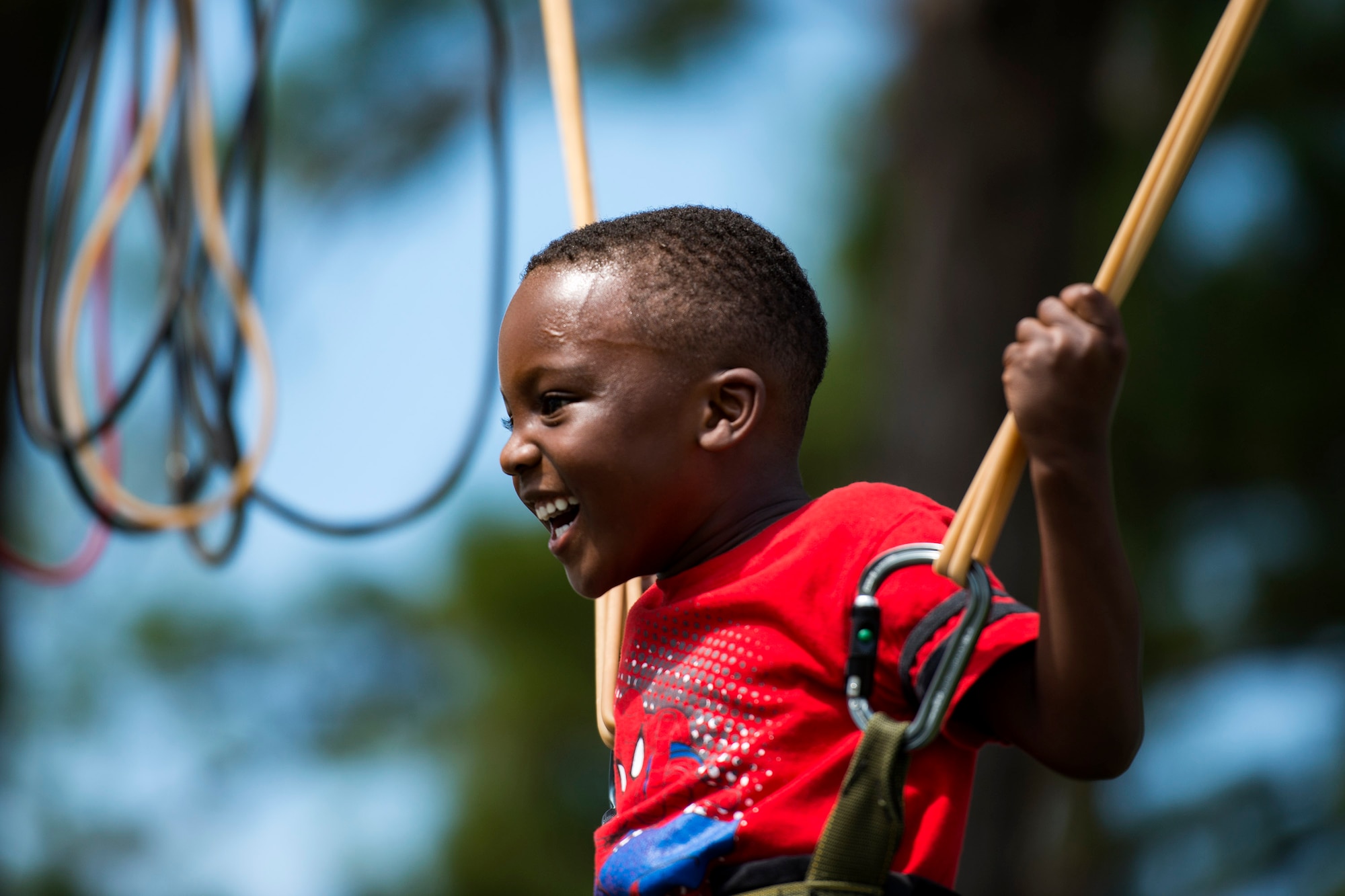 A participant jumps on a trampoline during the Patriot Festival, July 3, 2018, at Moody Air Force Base, Ga. Team Moody hosted the free event to allow Airmen and their families an opportunity to take some time away from the mission and enjoy a Fourth of July experience. The event consisted of live music, food trucks, family fun and a firework show. (U.S. Air Force photo by Airman 1st Class Erick Requadt)