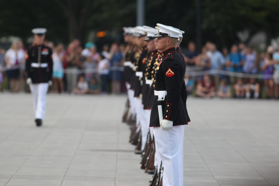 Corporal Ryan Watkins, rifle inspector, U.S. Marine Corps Silent Drill Platoon, prepares to execute a rifle inspection during a Tuesday Sunset Parade at the Lincoln Memorial, Washington, D.C., July 3, 2018. The guest of honor for the parade was Vice Adm. Walter E. “Ted” Carter, 62nd superintendent of the U.S. Naval Academy, and the hosting official was Lt. Gen. Robert S. Walsh, commanding general, Marine Corps Combat Development Command, and deputy commandant, Combat Development and Integration.(Official U.S. Marine Corps photo by Lance Cpl. James Bourgeois/Released)