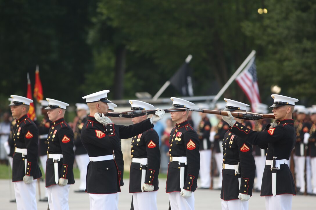 Corporal Ryan Watkins, rifle inspector, U.S. Marine Corps Silent Drill Platoon, performs precision rifle drill maneuvers during a Tuesday Sunset Parade at the Lincoln Memorial, Washington, D.C., July 3, 2018. The guest of honor for the parade was Vice Adm. Walter E. “Ted” Carter, 62nd superintendent of the U.S. Naval Academy, and the hosting official was Lt. Gen. Robert S. Walsh, commanding general, Marine Corps Combat Development Command, and deputy commandant, Combat Development and Integration.(Official U.S. Marine Corps photo by Lance Cpl. James Bourgeois/Released)