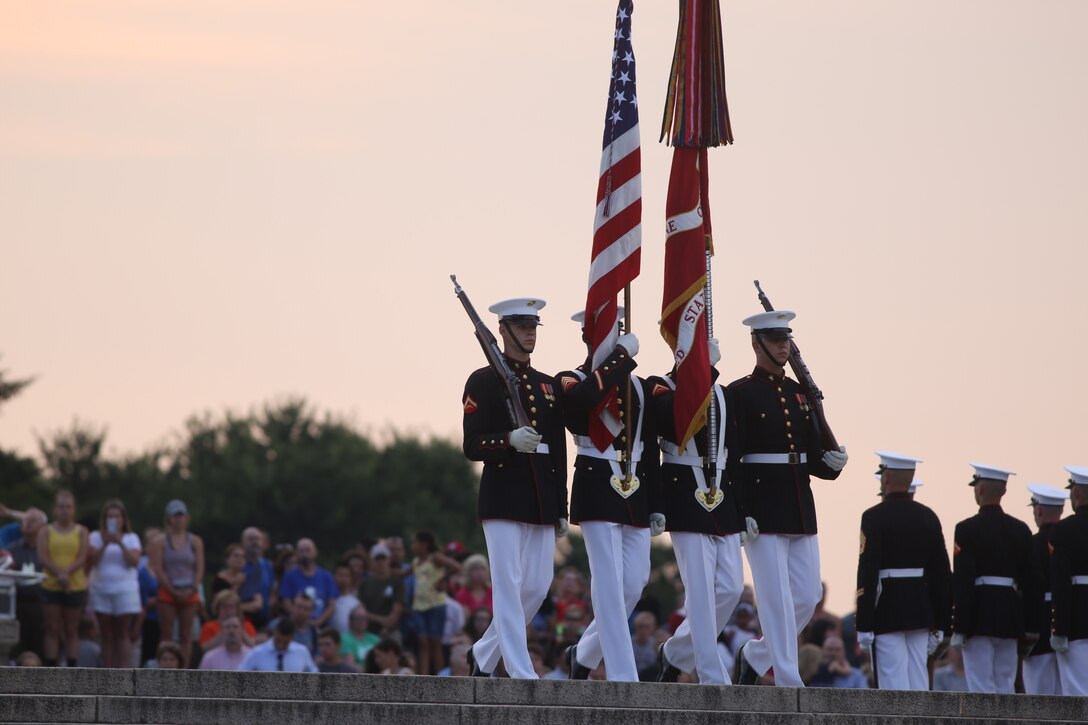 Marines with the U.S. Marine Corps Color Guard march the National Ensign and the U.S. Marine Corps Battle Colors off the parade deck during the Tuesday Sunset Parade at the Lincoln Memorial, Washington D.C., July 3, 2018. The guest of honor for the parade was Vice Adm. Walter E. “Ted” Carter, 62nd superintendent of the U.S. Naval Academy, and the hosting official was Lt. Gen. Robert S. Walsh, commanding general, Marine Corps Combat Development Command, and deputy commandant, Combat Development and Integration.(Official U.S. Marine Corps photo by Lance Cpl. James Bourgeois/Released)