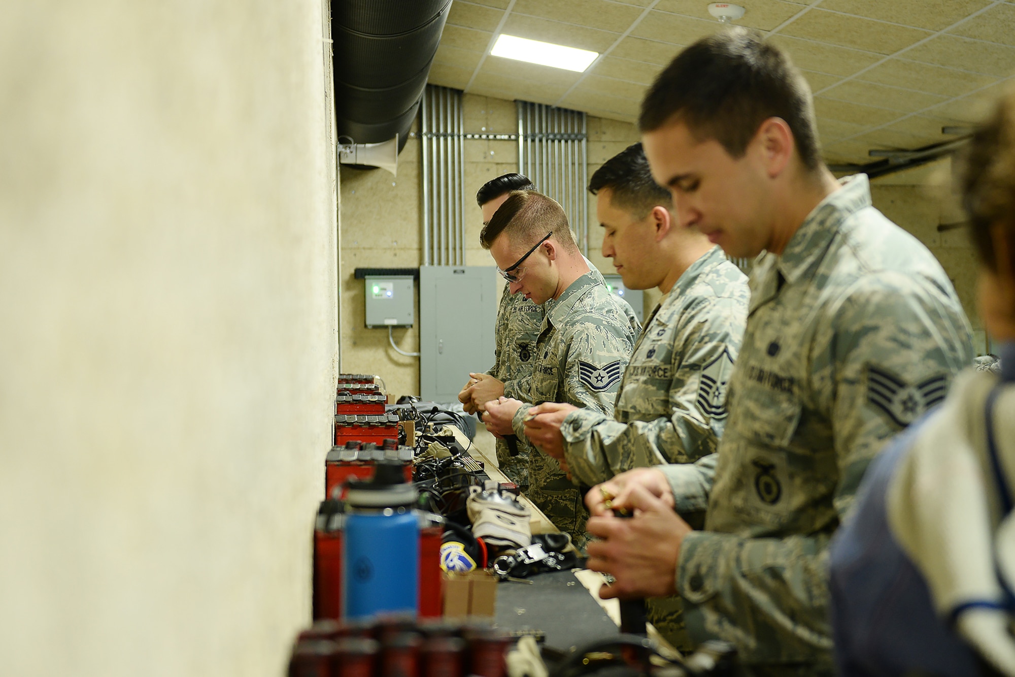 55th Security Forces Squadron airmen load bullets into magazines during an excellence in competition and shooting event May 14, 2018, at Offutt Air Force Base, Nebraska. The event was part of National Police Week which gives special recognition to all law enforcement officers who have dedicated their lives to protecting communities through service. (U.S. Air Force photo by Charles J. Haymond)