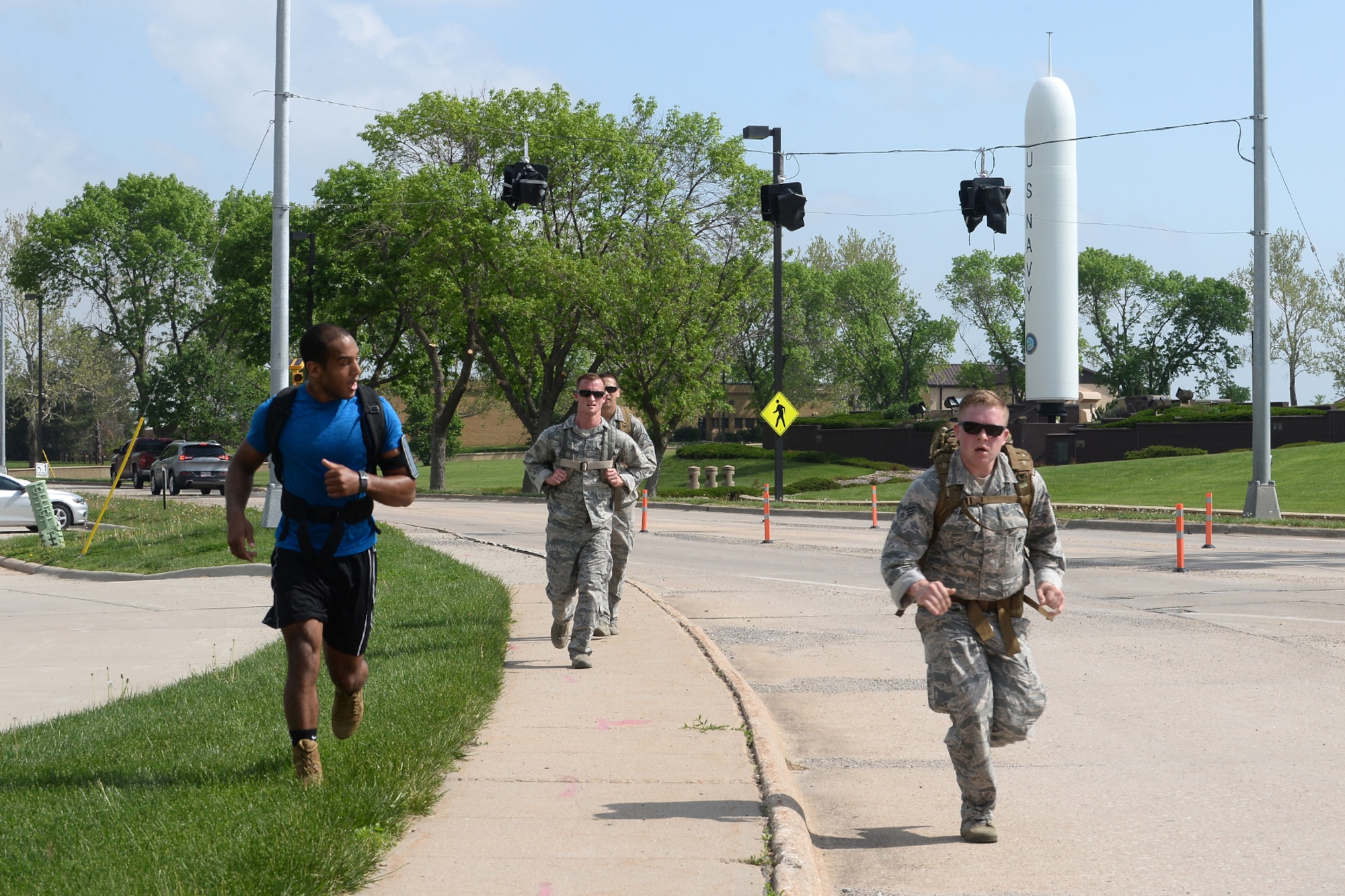 55th Security Forces Squadron Airmen approach the finish line during a ruck march challenge May 14, 2018, at Offutt Air Force, Nebraska. Team two ran and walked 2 miles from the the Patriot Club parking lot to Peacekeeper Drive in 38 minutes and 25 seconds to earn first place in this challenge. (U.S. Air Force photo by Charles J. Haymond)