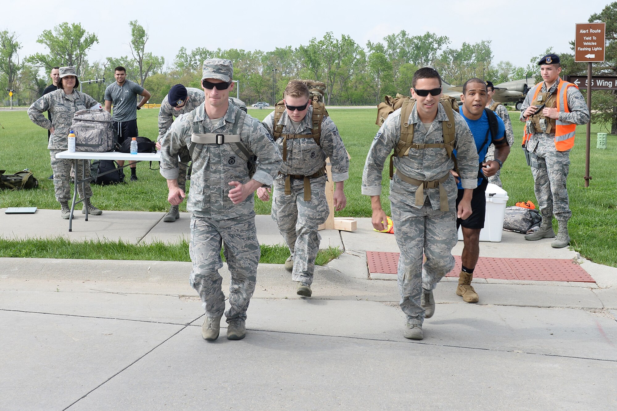 55th Security Forces Squadron Airmen begin to run during a ruck march challenge May 14, 2018, at Offutt Air Force Base, Nebraska. Team two ran and walked 2 miles from the Patriot Club parking lot to Peacekeeper Drive in 38 minutes and 25 seconds to earn first place in this challenge.  (U.S. Air Force photo by Charles J. Haymond)