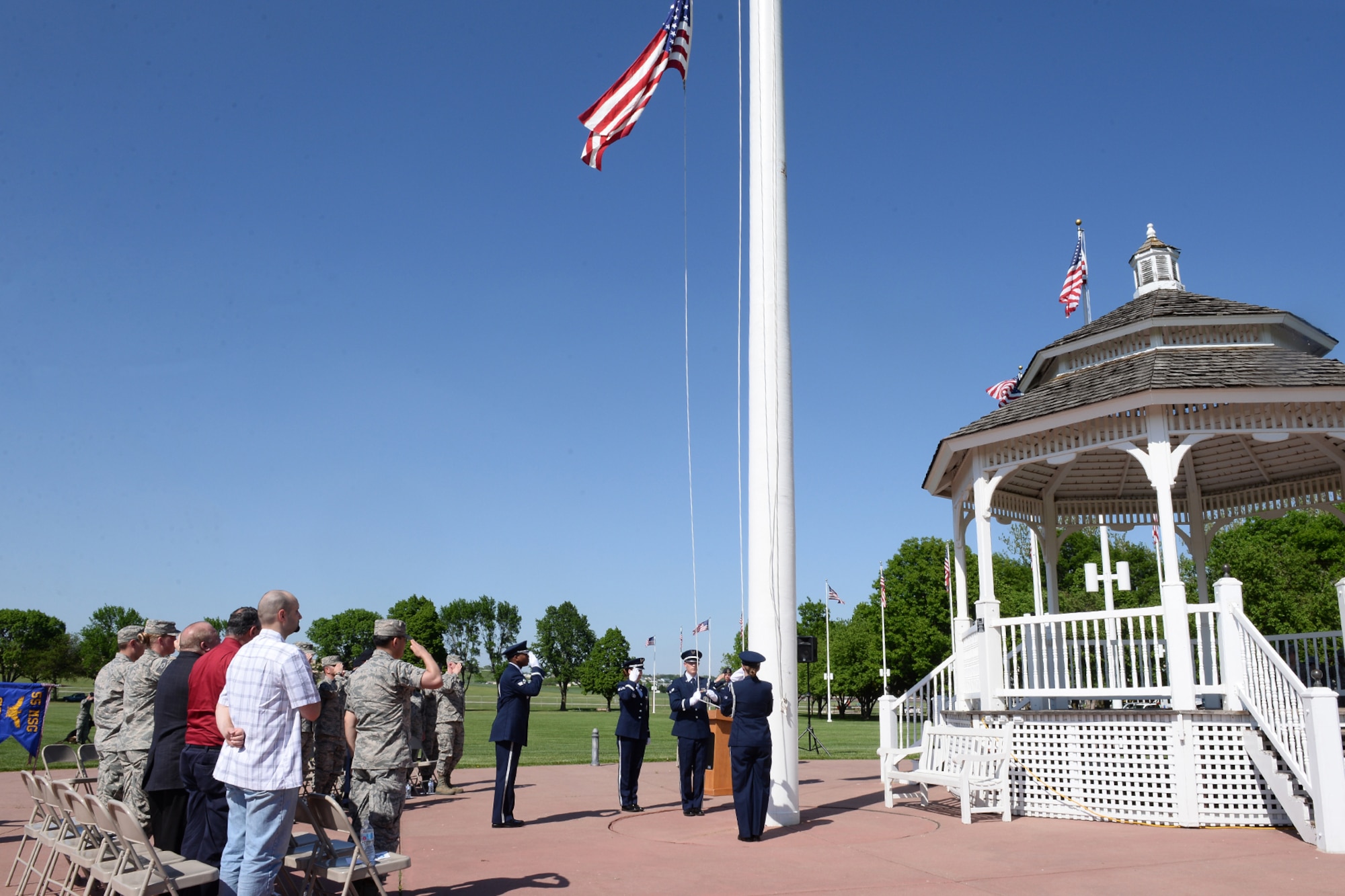 Offutt Air Force Base Honor Guard lower the U.S. flag during a retreat ceremony honoring Police Week May 17, 2018, at Offutt Air Force Base, Nebraska. Offutt’s defenders participated in local events as well as coordinating base events to recognize the contributions of police across the nation. (U.S. Air Force photo by Charles J. Haymond)