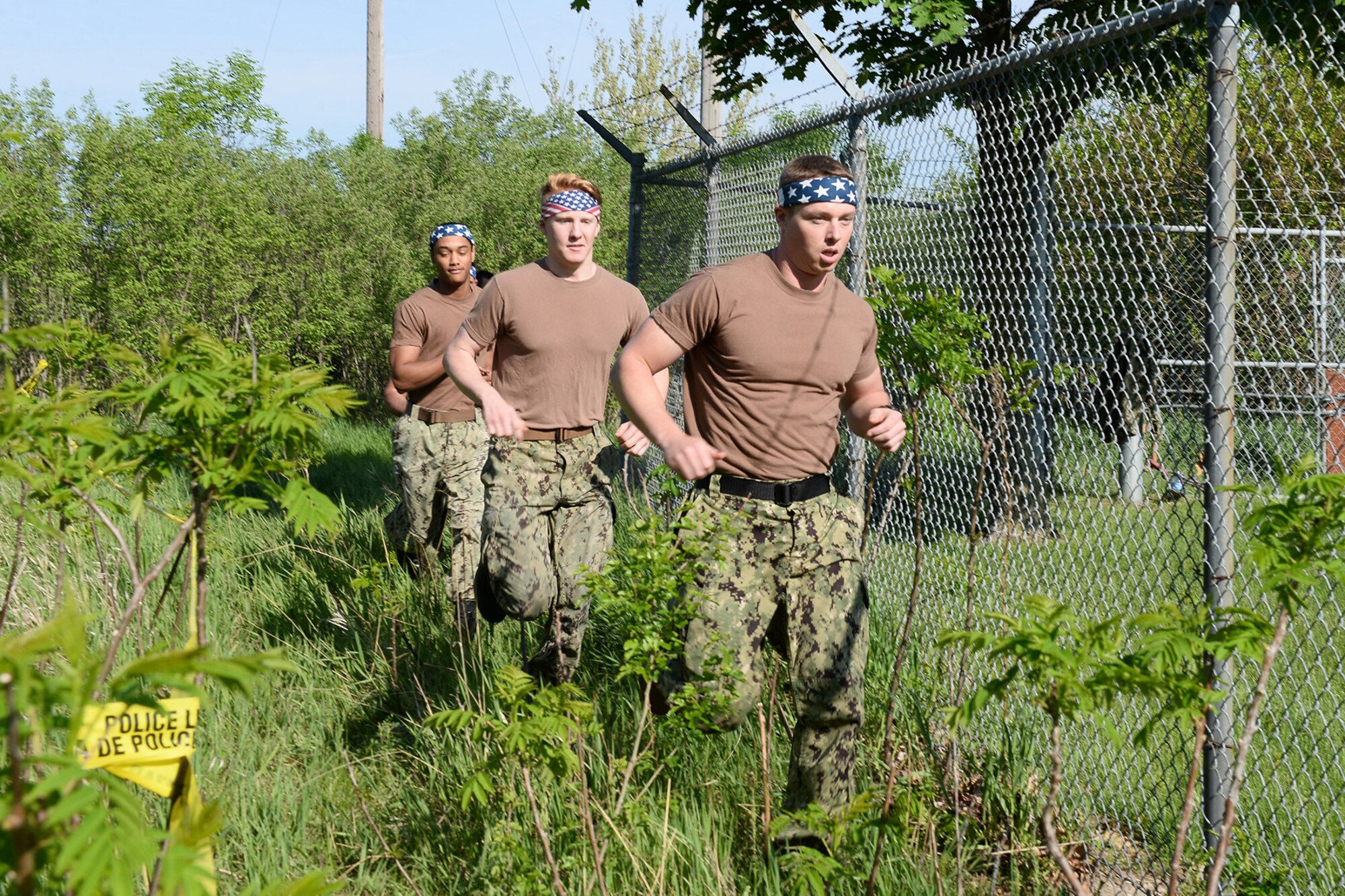 U.S. Navy Master of Arms third class Brian Schumann, 55th Security Forces Squadron, leads his team during an evasion challenge May 17, 2018, along the perimeter of Offutt Air Force Base, Nebraska. Offutt’s defenders participated in local events as well as coordinating base events to recognize the contributions of police across the nation. (U.S. Air Force photo by Charles J. Haymond)