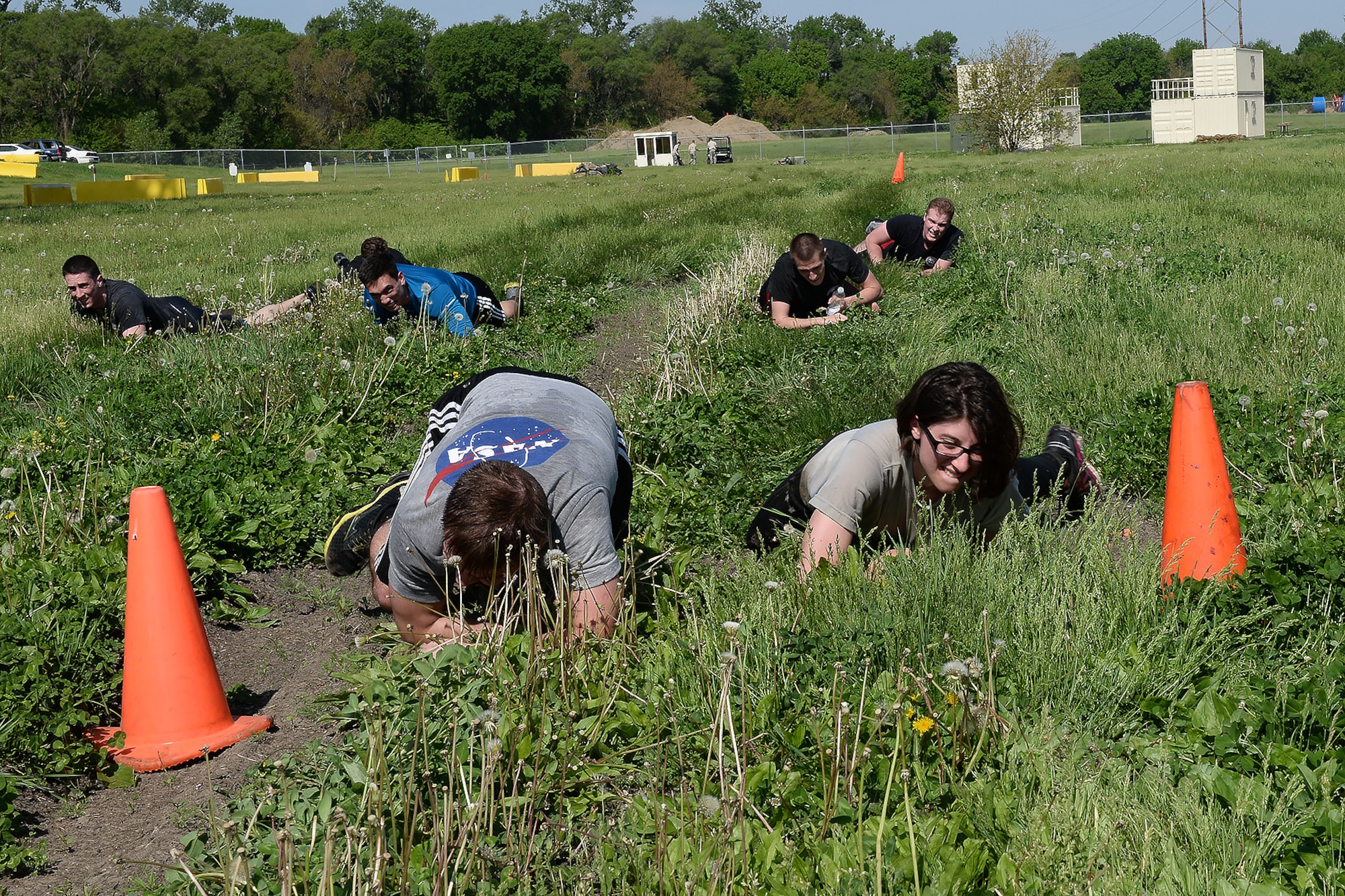 Members of the 55th Security Forces Squadron low crawl during an evasion challenge May 17, 2018, at Offutt Air Force Base, Nebraska. Offutt’s defenders participated in local events as well as coordinating base events to recognize the contributions of police across the nation. (U.S. Air Force photo by Charles J. Haymond)