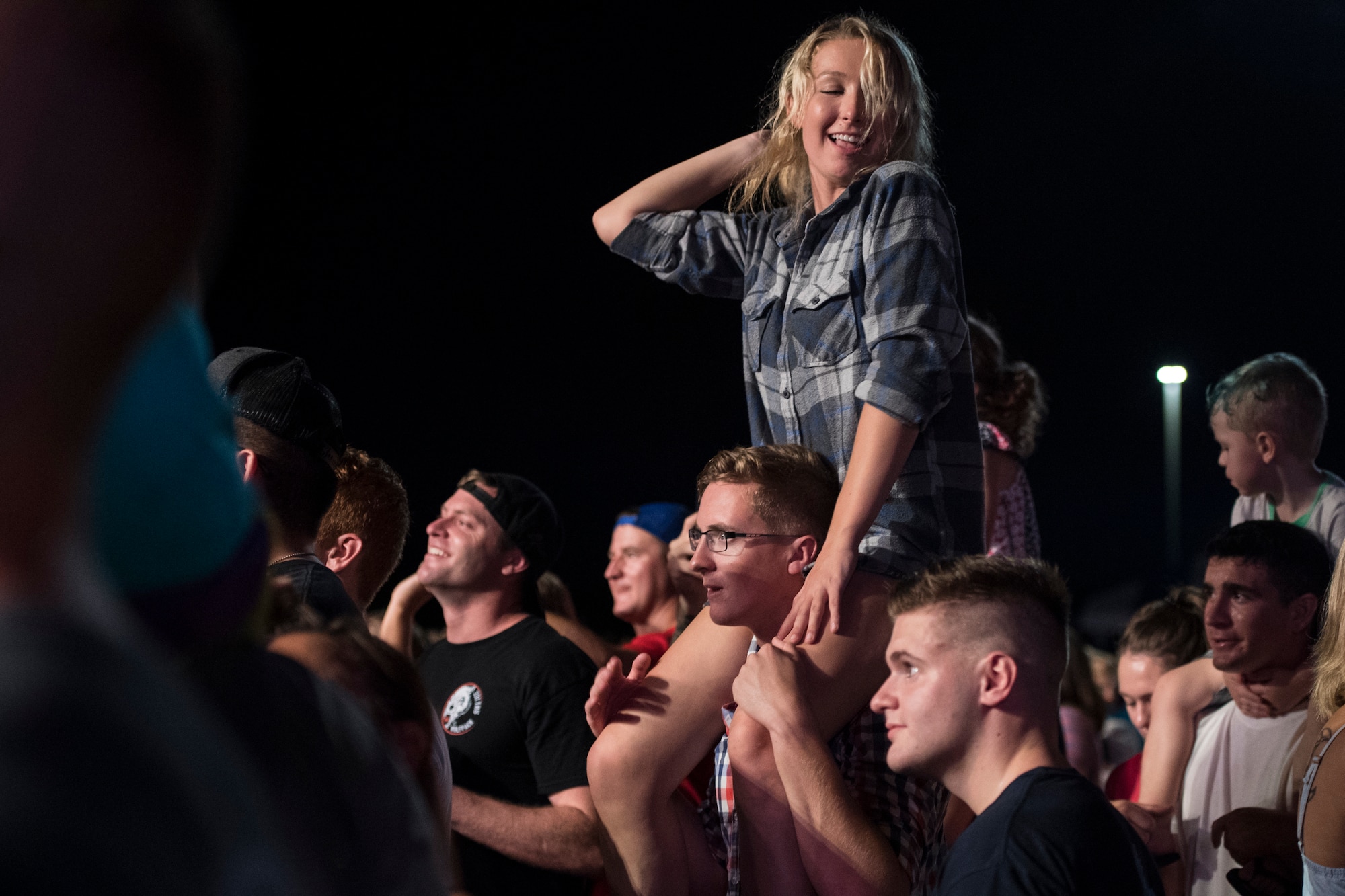 An attendee dances during Patriot Fest, July 3, 2018, at Moody Air Force Base, Ga. Team Moody hosted the free event to allow Airmen and their families an opportunity to take some time away from the mission and enjoy a Fourth of July experience. The event consisted of live music, food trucks, family fun and a fireworks show. (U.S. Air Force photo by Senior Airman Janiqua P. Robinson)