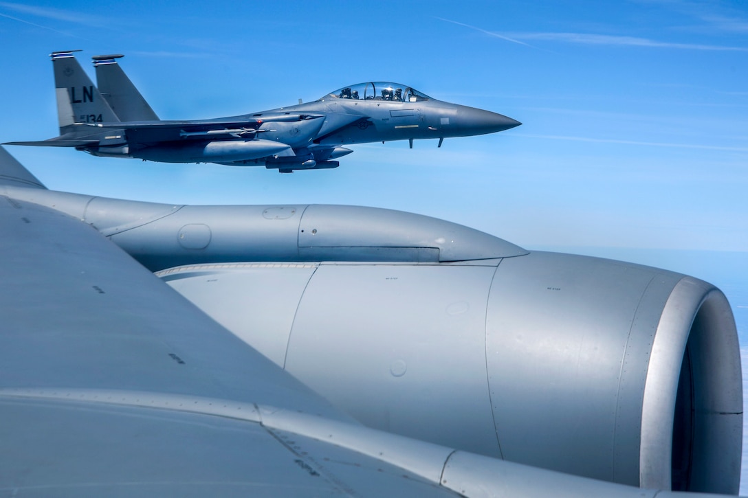 Two aircraft fly together.