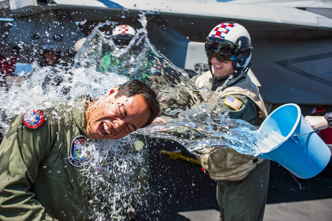 A sailor gets splashed with water.