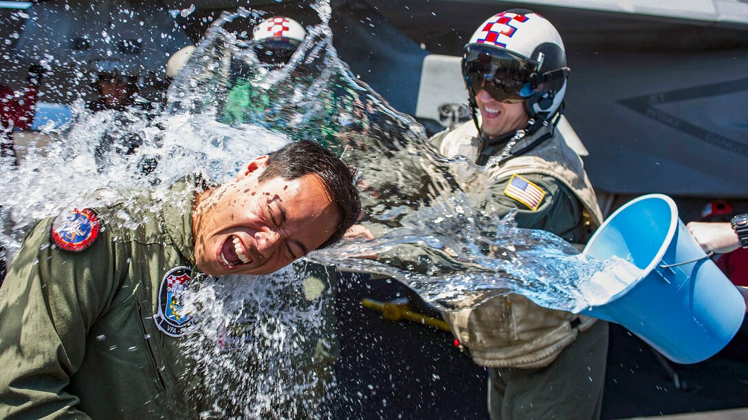 A sailor gets splashed with water.