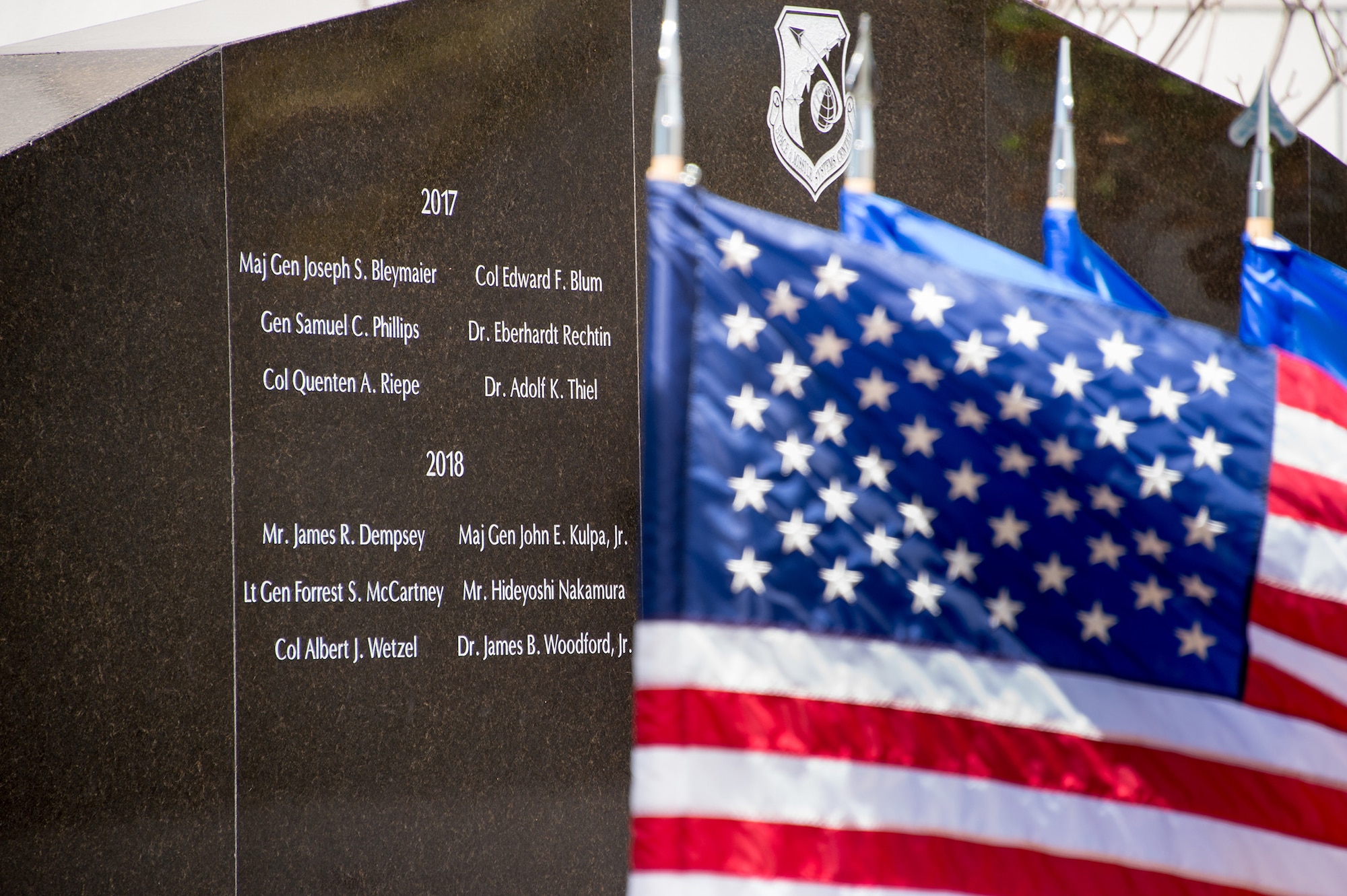 Six newly inducted Air Force and civilian space pioneers are inscribed on a wall of polished black granite at the General Bernard A. Schriever Memorial, located on the grounds of the Space and Missile Systems Center at Los Angeles Air Force Base in El Segundo, California, May 14, 2018. (U.S. Air Force photo/Van De Ha)