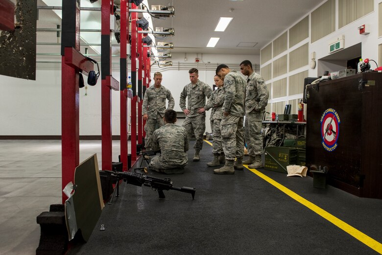 The 374th Security Forces Squadron 2018 Security Forces Advanced Combat Skills Assessment team learn more about the interworking of the M249 light machine gun, May 31, 2018, at Yokota Air Base, Japan.