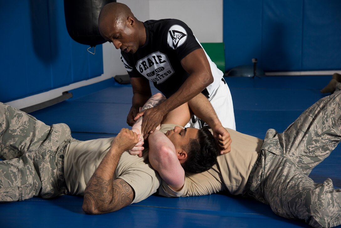 Maj. Tyrone Bess, combatives and Jiu-Jitsu instructor, teaches members of the 374th Security Forces Squadron 2018 Security Forces Advanced Combat Skills Assessment team hand-to-hand combat techniques, May 21, 2018, at Yokota Air Base, Japan.