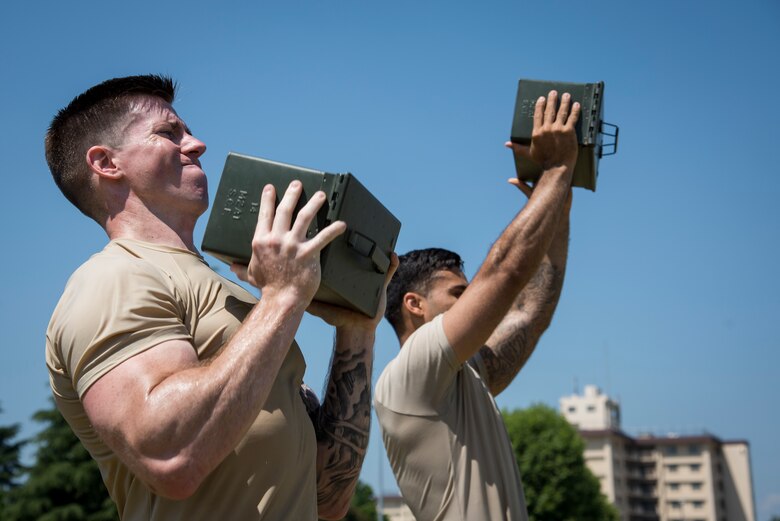 Staff Sgt. Daniel Lanata, 374th Security Forces Squadron 2018 Security Forces Advanced Combat Skills Assessment team member, performs ammo can lift during group physical training, June 1, 2018, at Yokota Air Base, Japan.