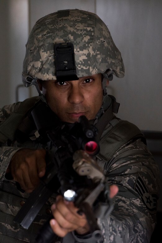 Staff Sgt. Oscar Gomez, 374th Security Forces Squadron 2018 Security Forces Advanced Combat Skills Assessment team lead, looks around a corner during tactical building clearing training, June 1, 2018, at Yokota Air Base, Japan.