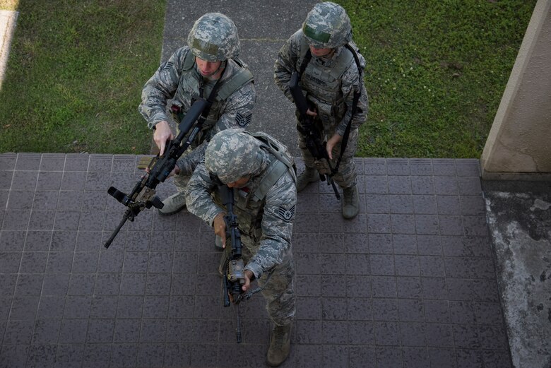 The 374th Security Forces Squadron 2018 Security Forces Advanced Combat Skills Assessment team, enter a building in formation during tactical building clearing training, June 1, 2018, at Yokota Air Base, Japan.