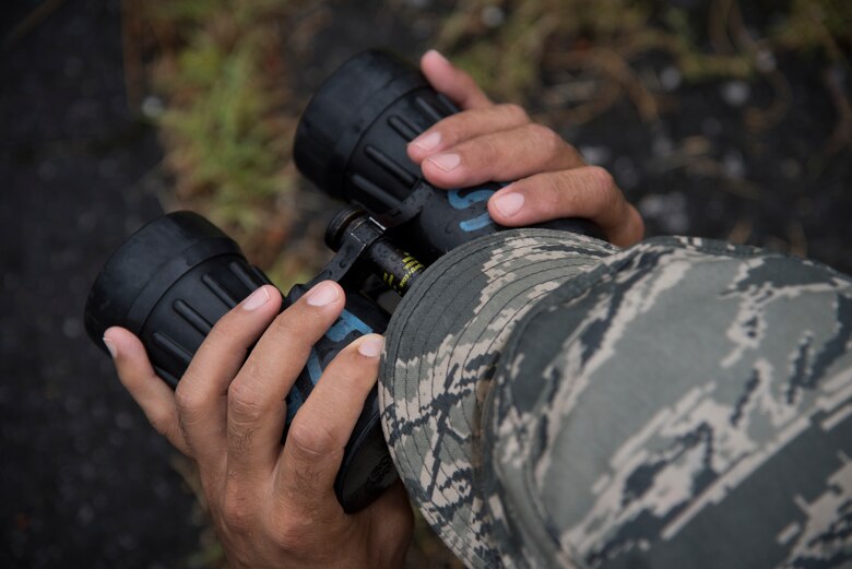 Staff Sgt. Oscar Gomez, 374th Security Forces Squadron 2018 Security Forces Advanced Combat Skills Assessment team lead, looks through binoculars during range-estimation training, June 1, 2018, at Yokota Air Base, Japan.