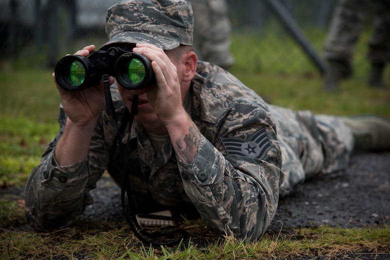 Staff Sgt. Daniel Lanata, 374th Security Forces Squadron 2018 Security Forces Advanced Combat Skills Assessment team member, looks through binoculars during range-estimation training, June 1, 2018, at Yokota Air Base, Japan.