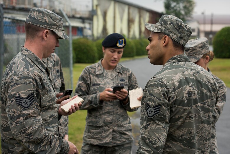 The 374th Security Forces Squadron 2018 Security Forces Advanced Combat Skills Assessment team compare findings and notes during range-estimation training, June 1, 2018, at Yokota Air Base, Japan.