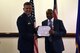 Edward Cole, 48th Fighter Wing community support director, receives the Outstanding Civilian Career Service Award during his retirement ceremony at Royal Air Force Lakenheath, England, June 29, 2018. The Outstanding Civilian Career Service Award is for civilian employees who, throughout their career, provided leadership or unusual competence, and their noteworthy accomplishments had a significant impact upon the Air Force mission. (U.S. Air Force photo/ Airman 1st Class John A. Crawford)