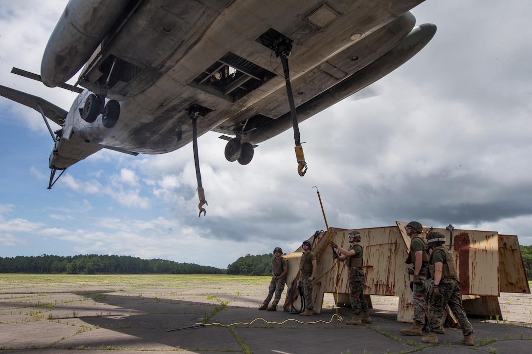 U.S. Marines with 2nd Transportation Support Battalion, Combat Logistics Regiment 2, help load a simulated vehicle during an external lift training exercise at Marine Corps Outlying Landing Field Atlantic, N.C., June 27, 2018. The training was conducted to enahnce readiness for landing support specialists with TSB-2 and Marine Heavy Helicopter Squadron 464.