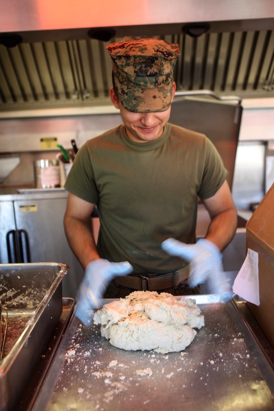 Lance Cpl. Jordan A. Delacruz, a food service Marine with Marine Wing Support Squadron 473, Marine Aircraft Group 41, 4th Marine Aircraft Wing, begins preparing food for The Major General W. P. T. Hill Memorial Awards competition for food service excellence on June 22, 2018 in Twentynine Palms, California, during Integrated Training Exercise 4-18. This competition encourages excellence in garrison and field food service. (United States Marine Corps photo by Cpl. Alexis B. Rocha)