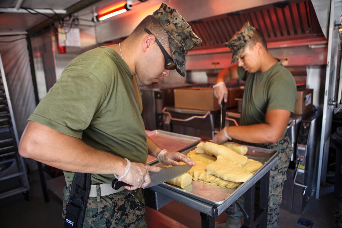 Lance Cpl. Joshua Murrati, a food service Marine with Marine Wing Support Squadron 473, Marine Aircraft Group 41, 4th Marine Aircraft Wing, begins preparing cookies for The Major General W. P. T. Hill Memorial Awards competition for food service excellence on June 22, 2018 in Twentynine Palms, California, during Integrated Training Exercise 4-18. This competition encourages excellence in garrison and field food service. (United States Marine Corps photo by Cpl. Alexis B. Rocha/released)