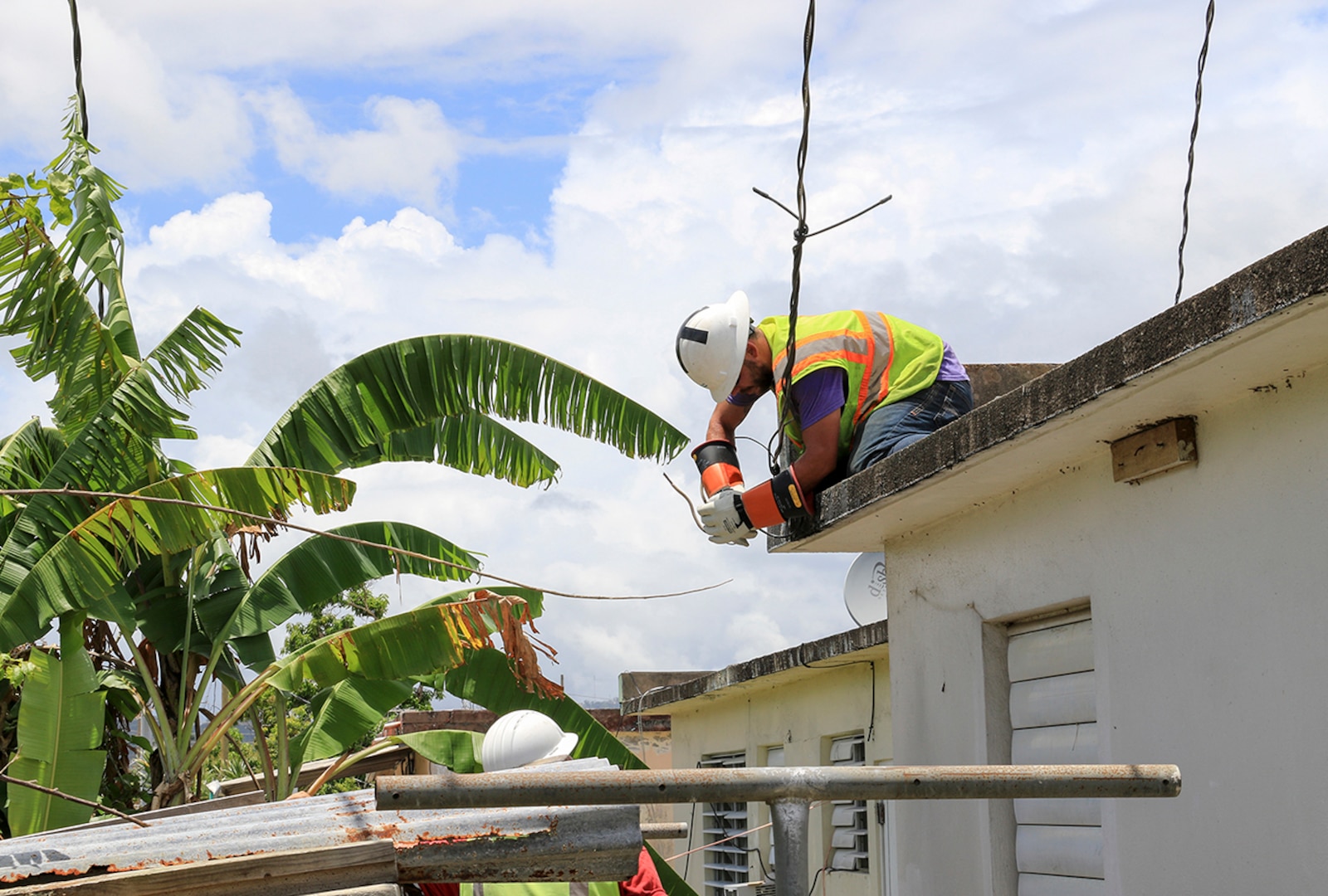 U.S. Army Corps of Engineers contractors work to restore the electrical grid in the Villa Alegria neighborhood of Caguas, Puerto Rico.