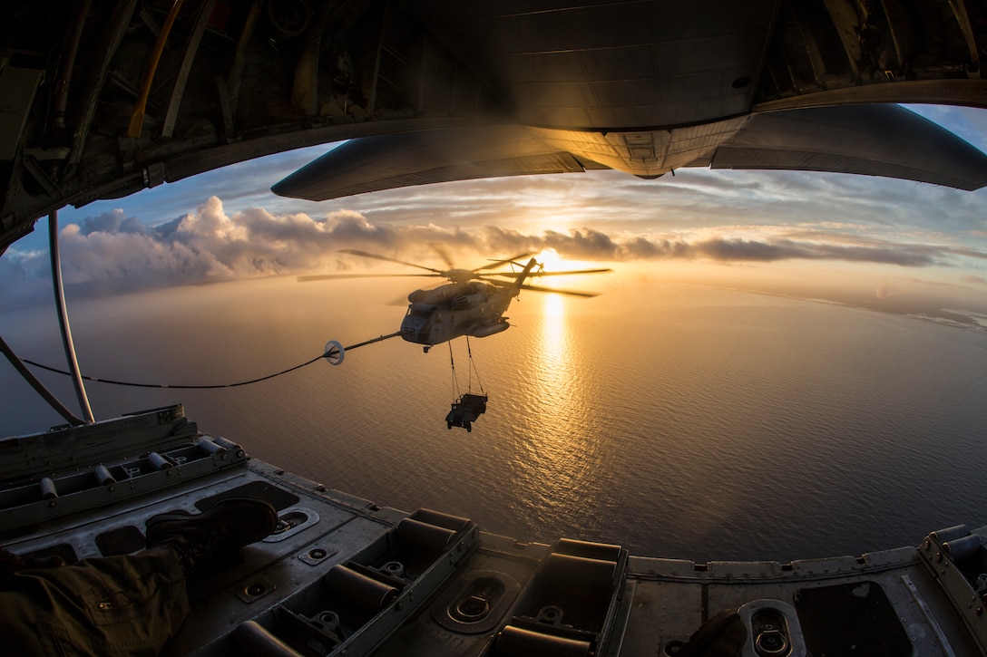 A CH-53 Super Stallion assigned to Marine Heavy Helicopter Squadron 464, carries a Humvee during an aerial refueling training operation with Marine Aerial Refueler Transport Squadron 234 on Feb. 23, 2017. VMGR-234 assisted HMH-464 in the training to maintain interoperability.