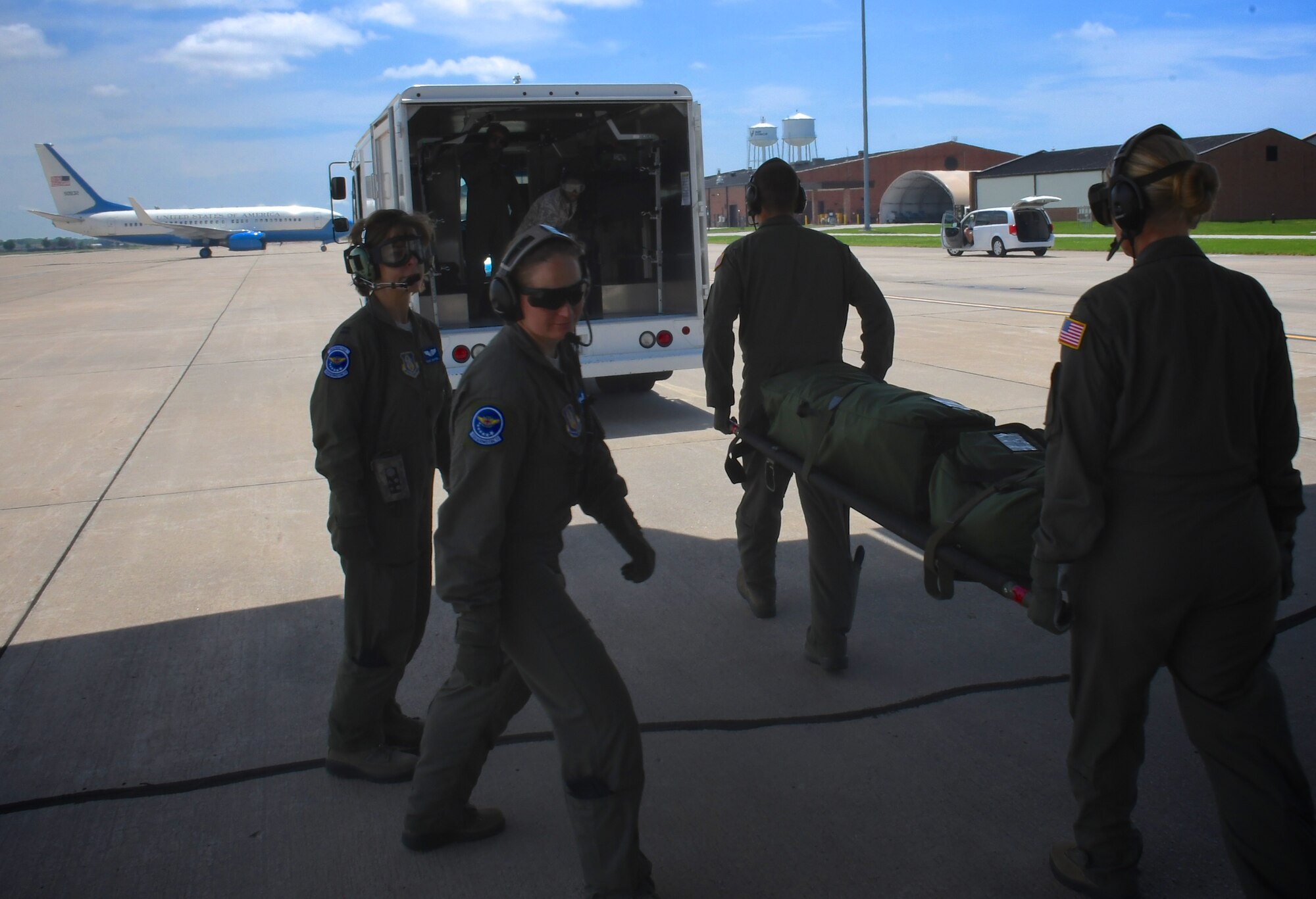 932nd Aeromedical Evacuation Squadron aircrew medical members make final arrangements to carry a litter of equipment back to their building, as they work together with ground crew, completing the end of a a training flight, May 19, 2018 at Scott Air Force Base, Ill. The AES trained alongside fellow nurses and medical technicians on a multi day flight aboard a C-130 aircraft visiting from the 910th Airlift Wing of Youngstown, Ohio. The 932nd Airlift Wing is a 22nd Air Force unit, under the Air Force Reserve Command, and is located at Scott Air Force Base, Ill. (U.S. Air Force photo by Lt. Col. Stan Paregien)