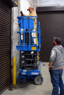 Bryan Broughton, a door mechanic,
prepares to install an electronic board
on one of the more than 750 rolldown
doors as Phillip Fitz, a heating,
ventilating and air conditioning controls
mechanic, looks on. The division
is implementing a plan that allows
employees in the field to access
information and input critical data
using computer tablets for greater
efficiency and timeliness.