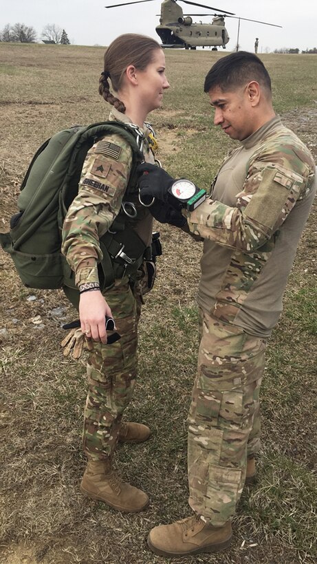 Army Sgt. First Class Franz Tovar, jumpmaster, conducts a pre-inspection of Army Staff Sgt. Brittany Sheehan before her military freefall jump.
